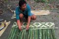 Weaving the amakan mat.